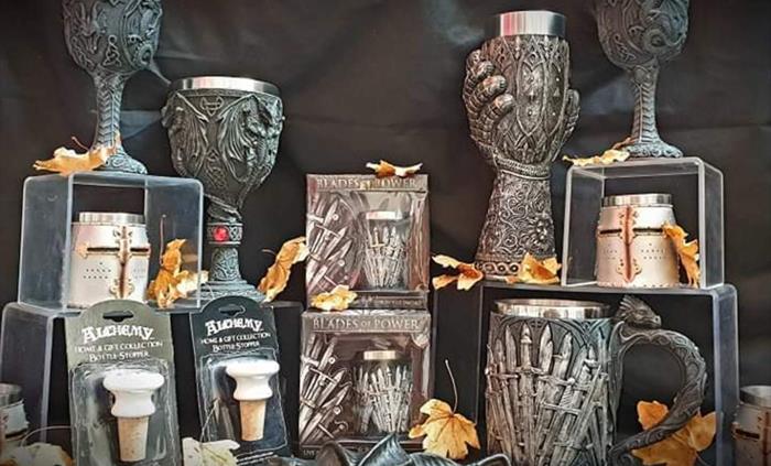 Goblets and shot glasses, dragon bottle stop and a bat bottle opener.